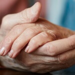Close-up of senior female hand in that of her husband