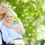 Seniore caregiver with senior in wheelchair